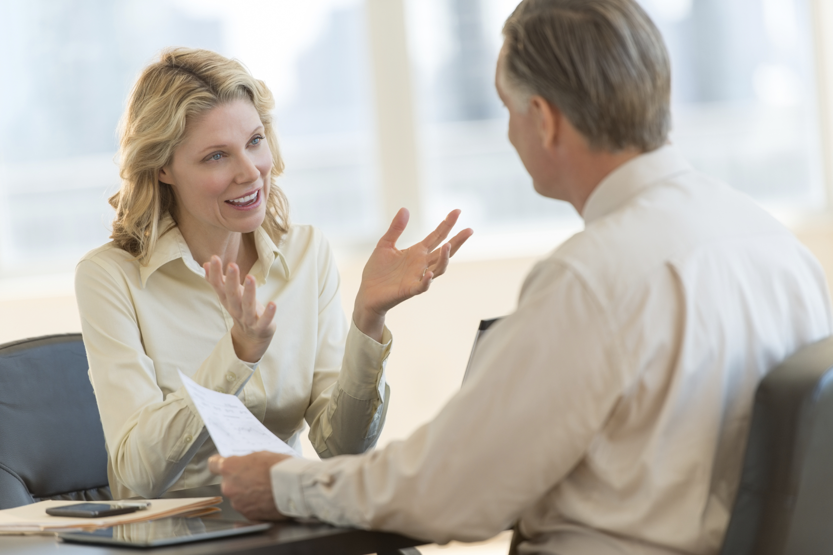 Businesswoman Discussing With Colleague In Office
